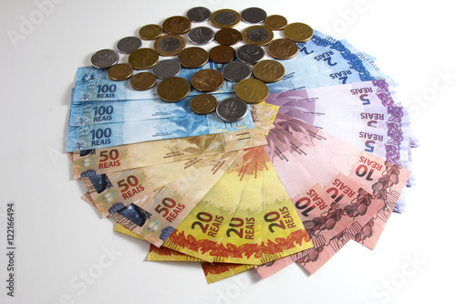 Brazilian fake money, bills and coins in a shape of a pizza.