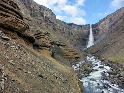 Hengifoss waterfall in Iceland with red rock striations 