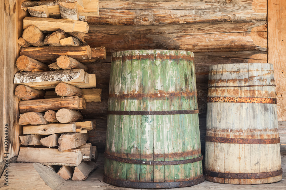 Old wooden barrels and firewood