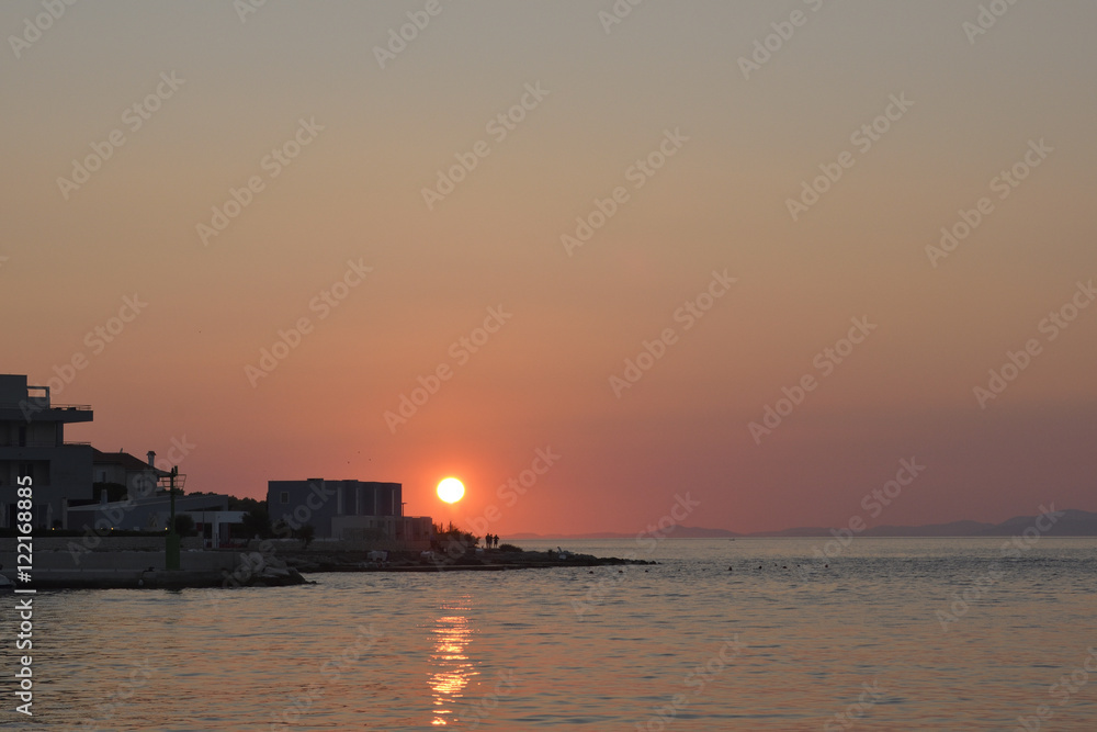 Sunset in Postira harbor on Brac Island in Croatia.