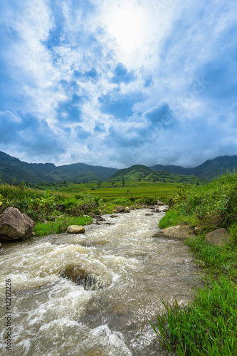Wild brook through the Terraced rice field and mountain view