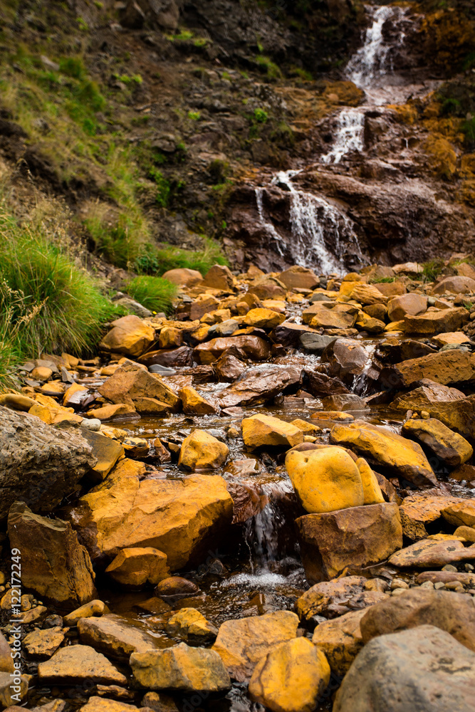 Small waterfall with yellow stones, Iceland. Small waterfall with yellow stones, Iceland.
