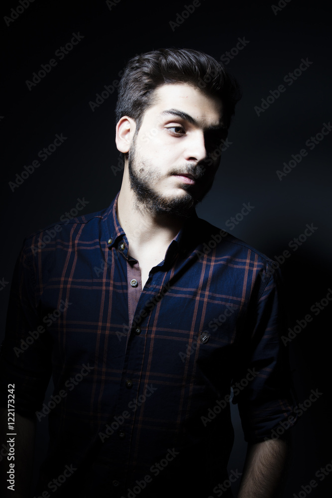Fototapeta premium Boy in darkness isolated inside Studio