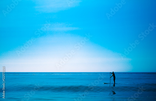 Boy on the beach with surf board,skimboard,and wave from the Pac