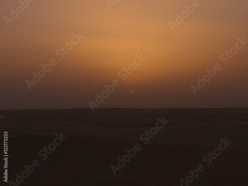 солнце садится за горизонт в пустыне Сахара