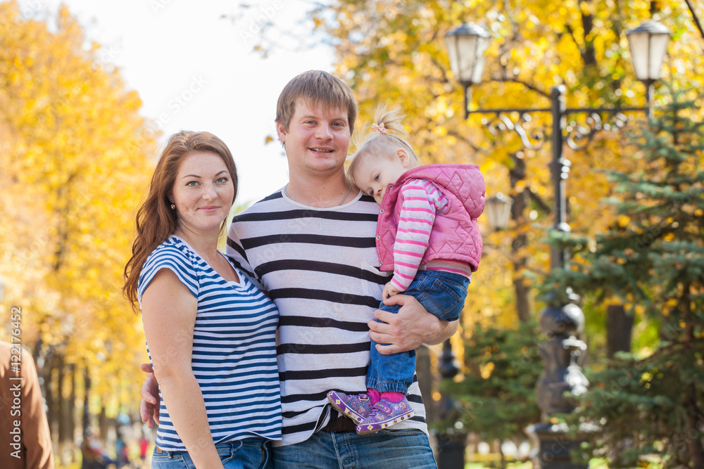 happy family in the same clothes for a walk in the park in autumn