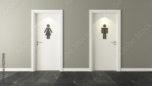 white restroom doors for male and female genders with spot light photo