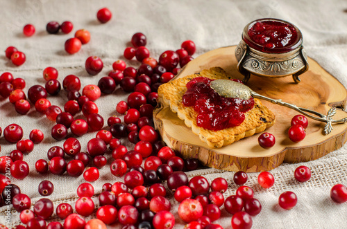 Breakfast with cranberries, jam and biscuits.