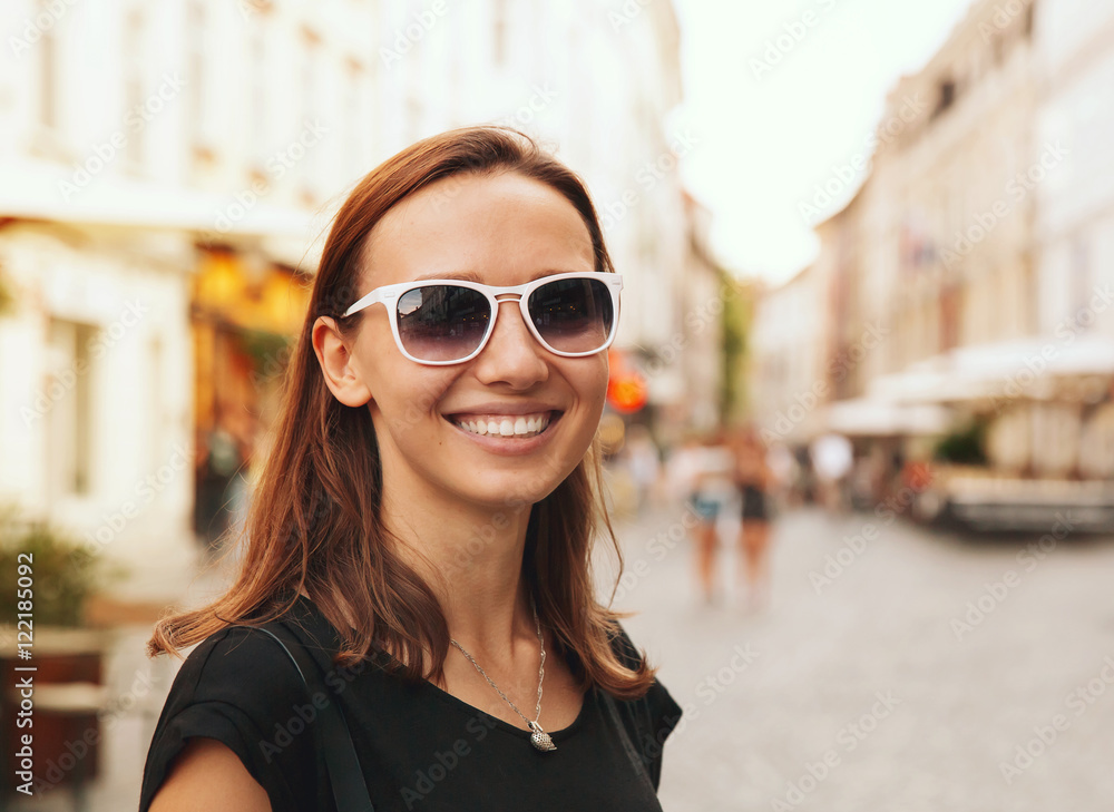 Smiling Woman on the Background of European Old Town Street.