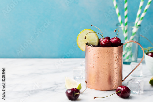 Photography Cold cherry Moscow Mules cocktail with ginger beer, vodka, lime Marble backgroun