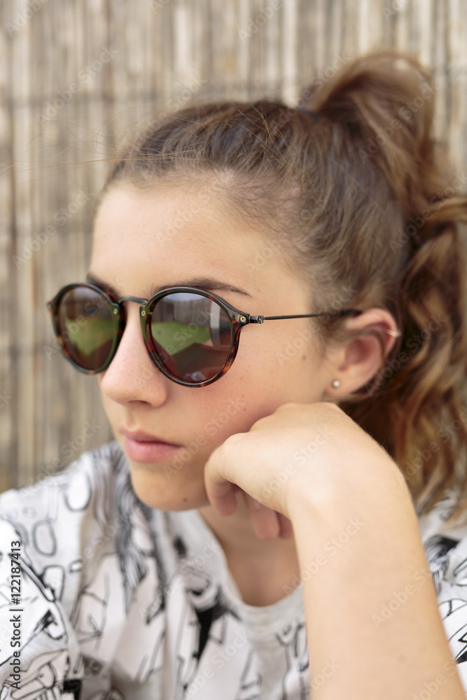 Young girl with sunglasses. vertical capture. Young girl with sunglasses. vertical capture.