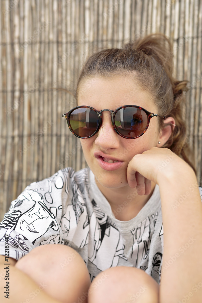 Young girl with sunglasses. vertical capture. Young girl with sunglasses. vertical capture.