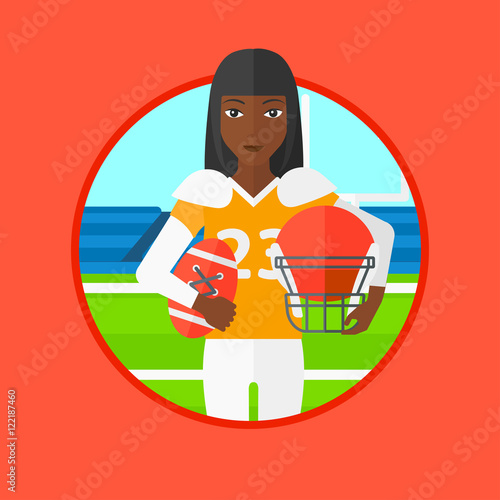 Rugby player with ball and helmet in hands.