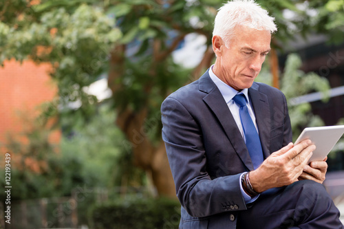 Senior businessman holding touchpad 