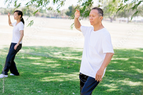 People practicing thai chi in park