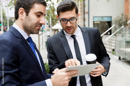 Two businessmen talking outdoors