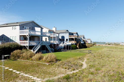 Luxury vacation beach rental houses along the green sand dunes  Sunset Beach, North Carolina © Richard McGuirk