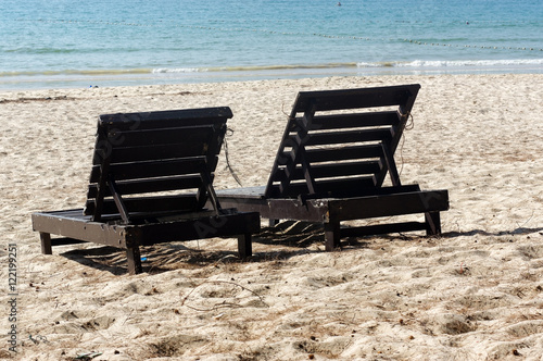 two wooden beach chairs on beautiful island in white sand plage