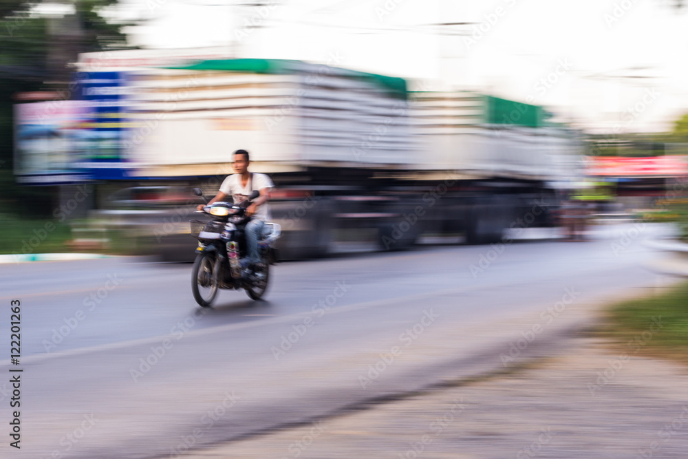 motorcycle panning in road, Asia