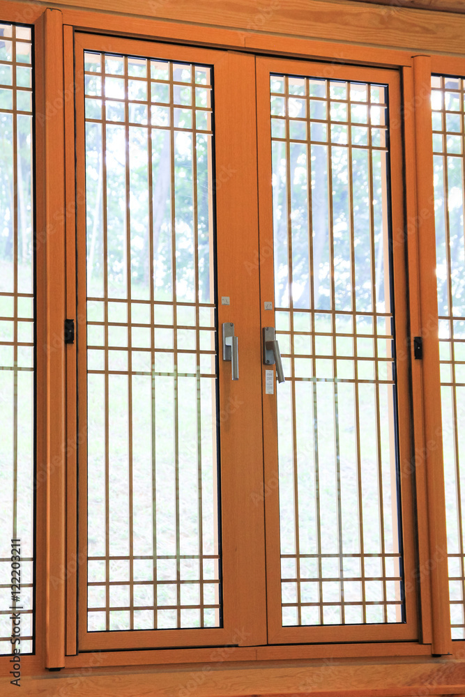traditional wooden window / A pattern view of traditional wooden window in the wooden house in korea traditional wooden window / A pattern view of traditional wooden window in the wooden house in korea