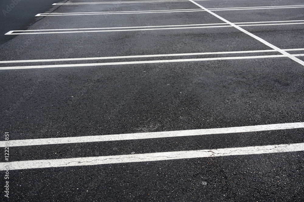 new paved empty parking lot with new painted strip lines