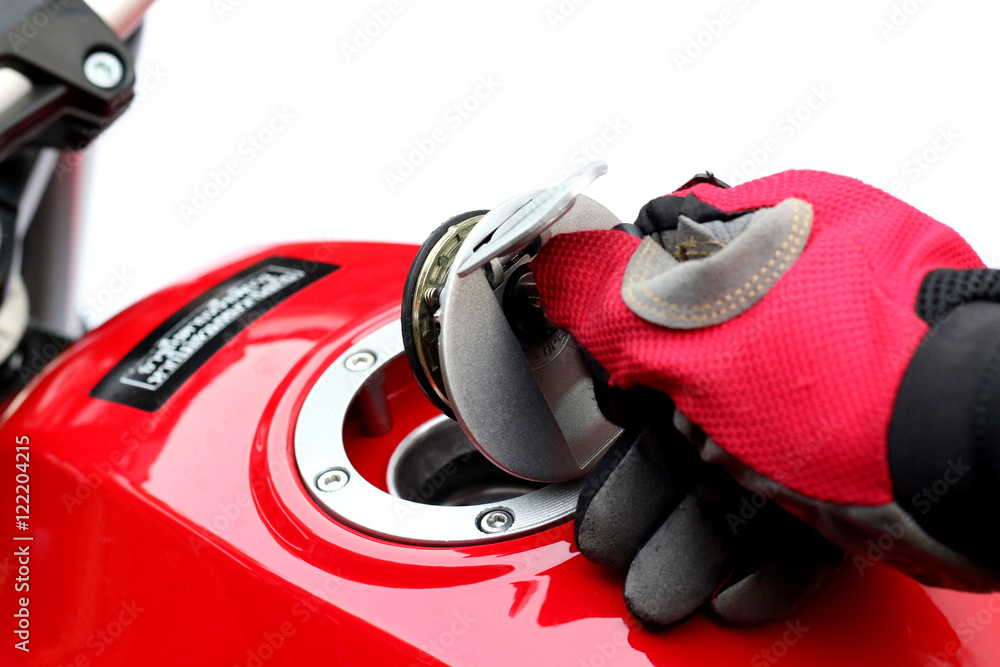 Fototapeta premium Men turn key motorcycle fuel tank.