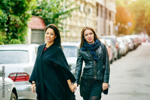 Two happy girls girlfriend walk through the streets of the city © fisher05