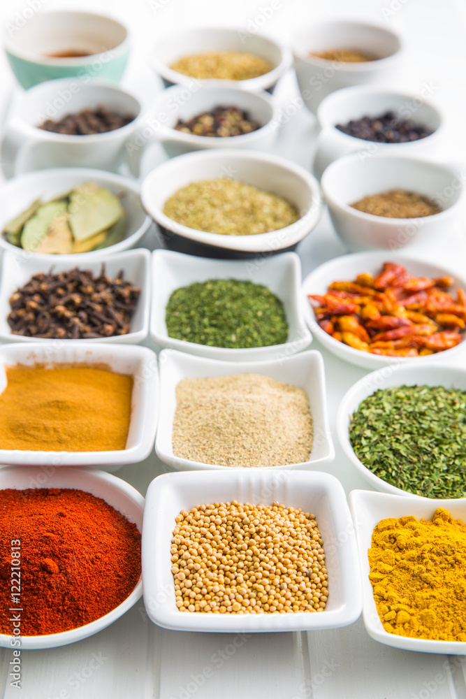 Various dried herbs and spices in bowl.