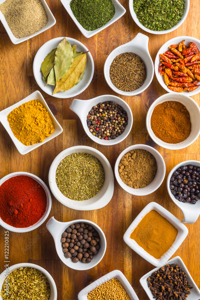 Various dried herbs and spices in bowl.