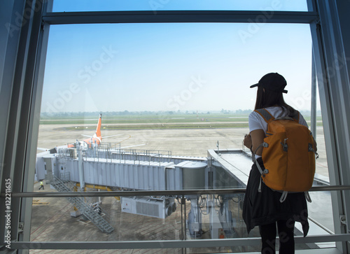 Wallpaper Mural Traveler woman at the airport window Torontodigital.ca