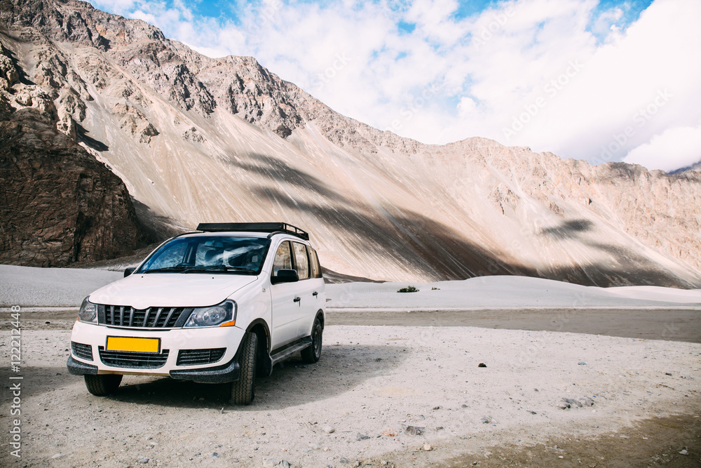 White car parked in highland mountain scene in Leh, India