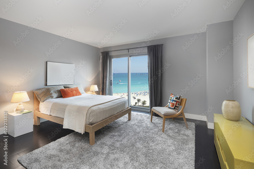 Fototapeta premium Grey bedroom with ocean sea view.