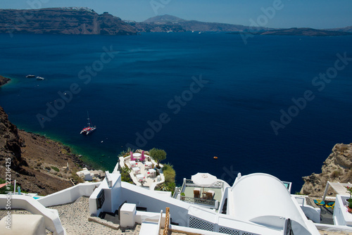 Tables and chairs ready for customers on a balcony at Fira, Santorini, Greece 