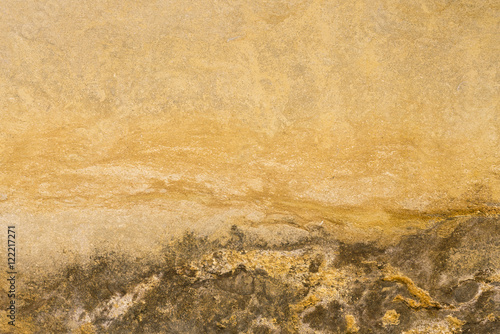 Yellow and brown stone surface with a crack, background, texture
