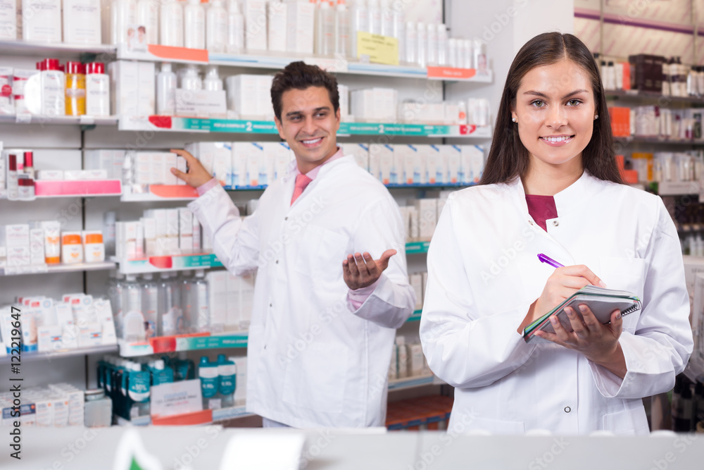 Two pharmacists in modern pharmacy