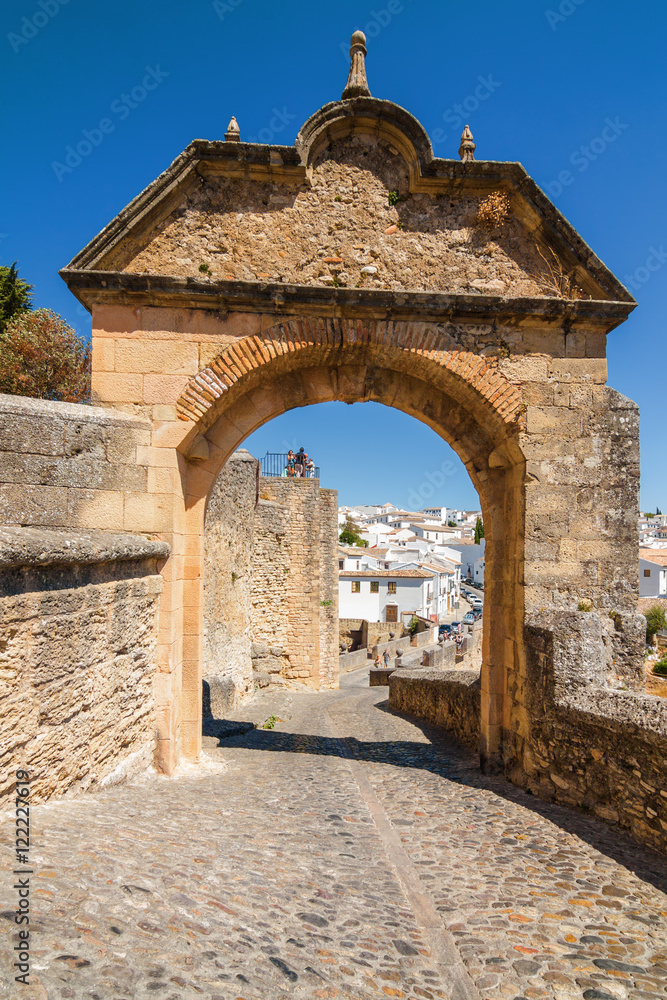 Sunny view of the town and the Arch of Felipe V in Ronda, Malaga province, Spain.