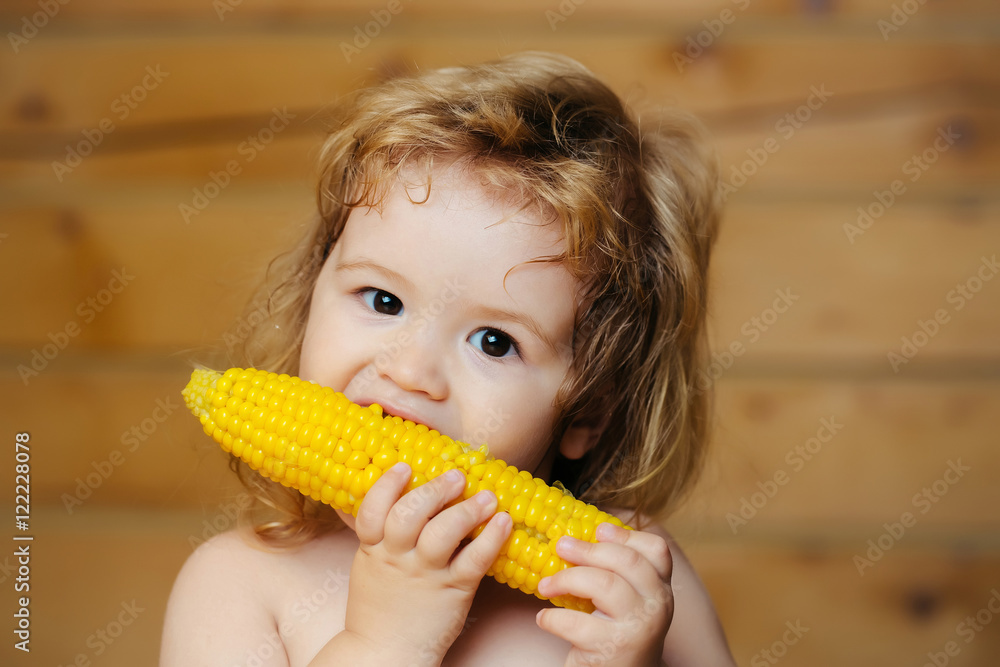 funny small boy child eating yellow corn funny small boy child eating yellow corn