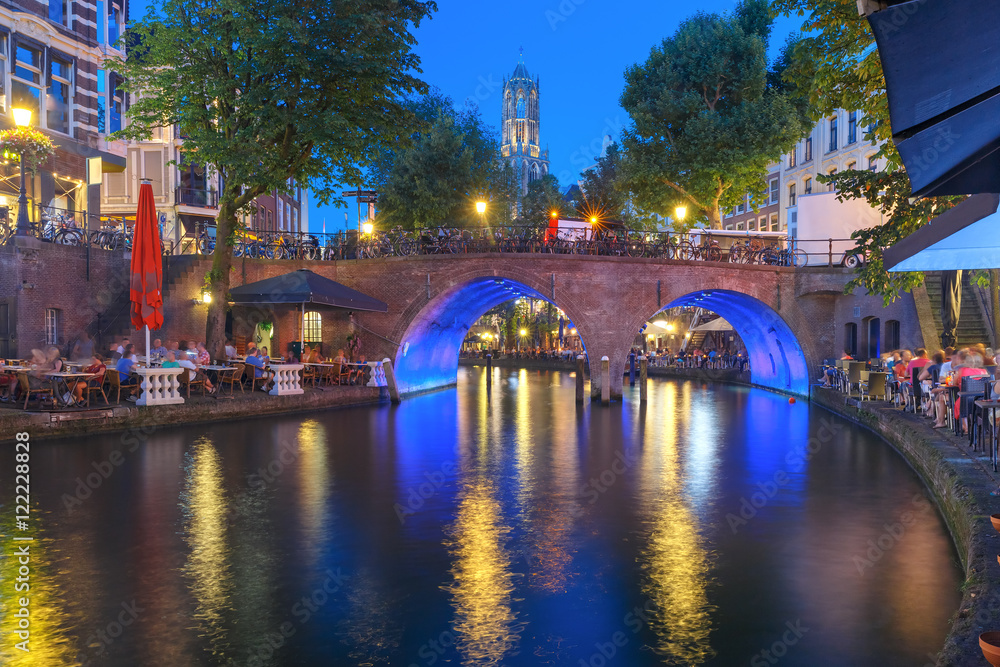 Dom Tower and canal Oudegracht in the night colorful illuminations in the blue hour, Utrecht, Netherlands