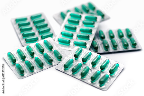 Green capsule blisters background