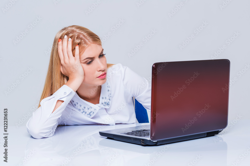 Young businesswoman working at laptop computer. Young businesswoman working at laptop computer.