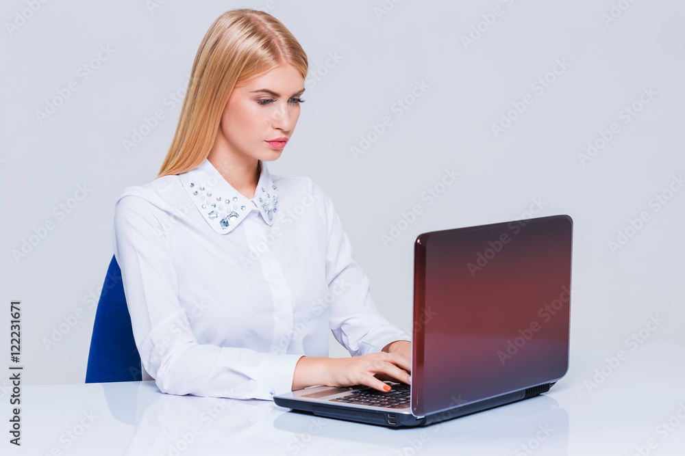 Young businesswoman working at laptop computer. Young businesswoman working at laptop computer.