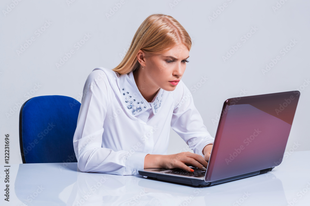 Young businesswoman working at laptop computer. Young businesswoman working at laptop computer.