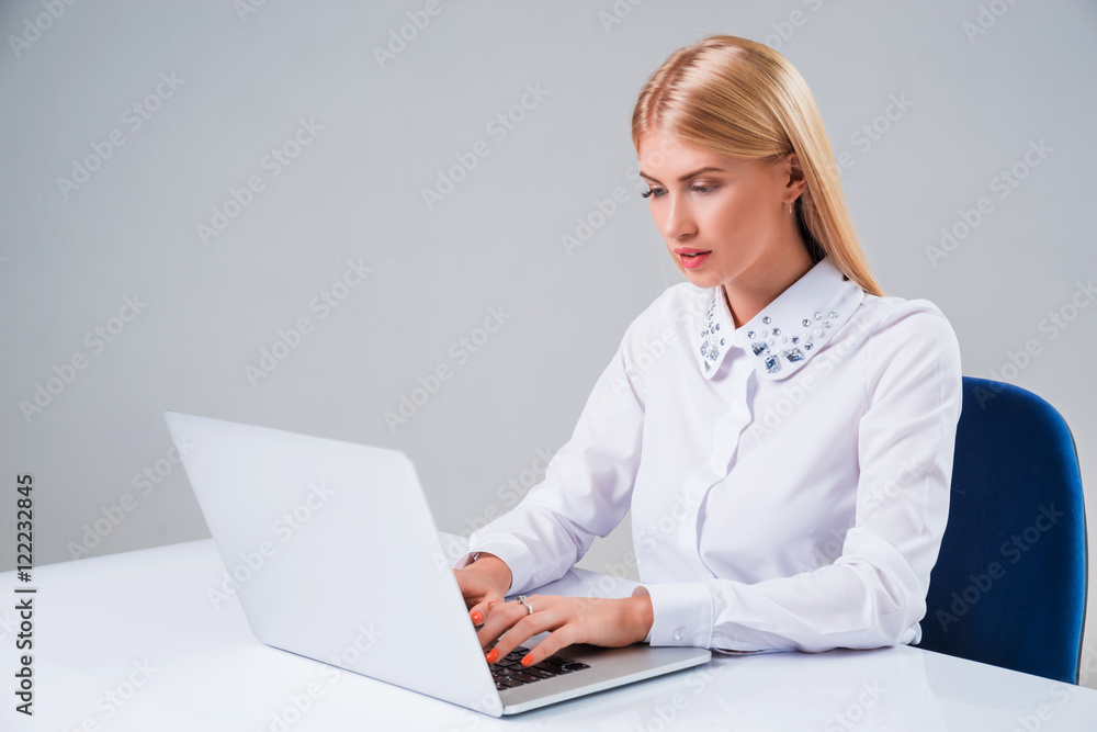 Young businesswoman working at laptop computer. Young businesswoman working at laptop computer.
