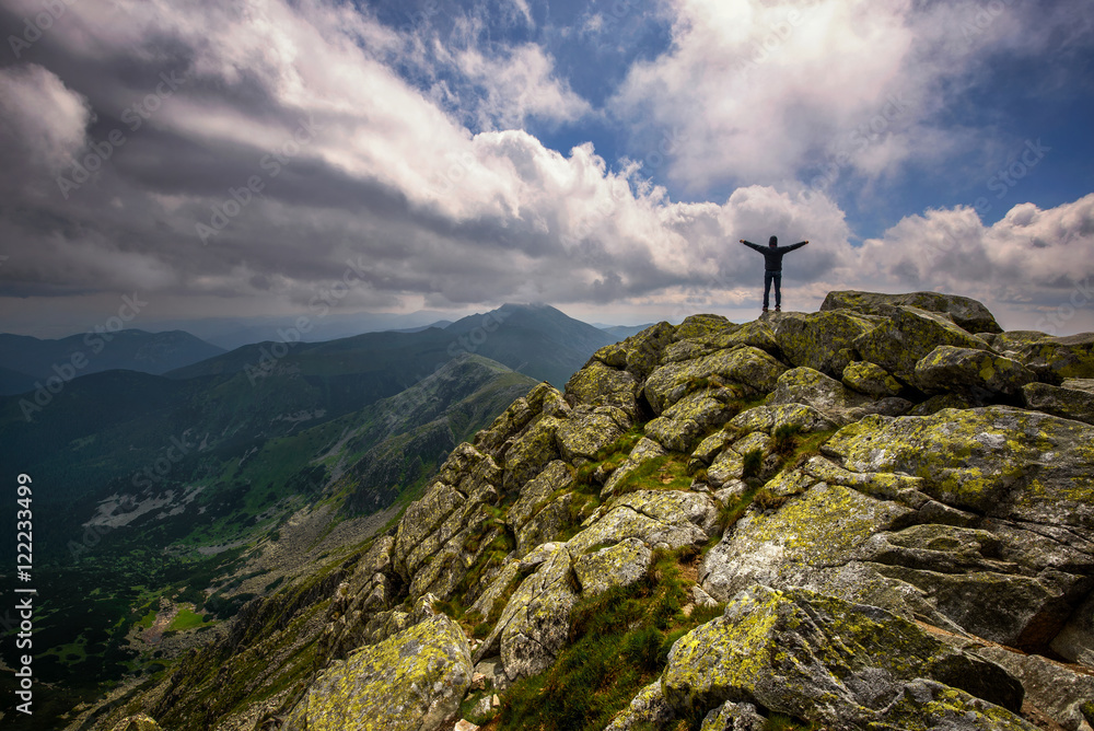 Obraz premium Mountain landscape and self portrait from hill Chopok in Low Tatras at Slovakia. Dramatic cloudy sky during summer day at mountain peak.