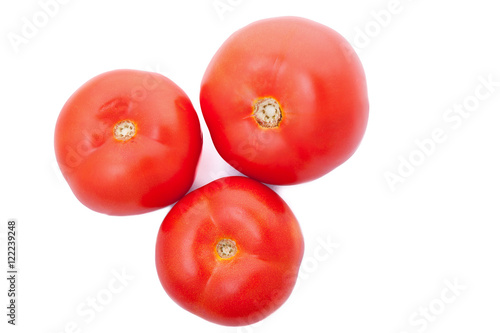 Three fresh tomatoes isolated over white background