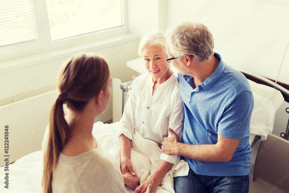 Fototapeta premium happy family visiting senior woman at hospital
