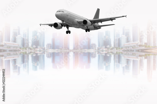 Civil aircraft with beautiful blurred skyscrapers background.