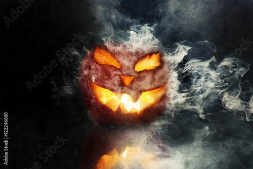 Burning halloween pumpkin on black background