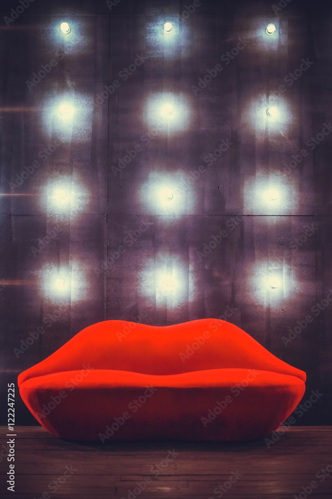 Beautiful luxury red lips sofa on grey background with lights Stock