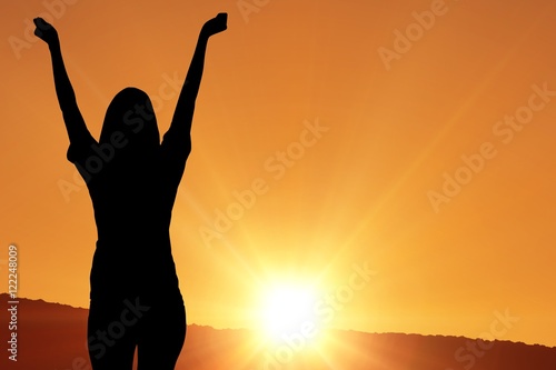 cheering silhouette on sunset background